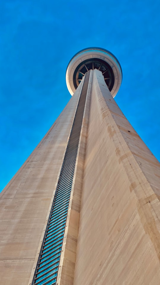 low angle photography of gray concrete building under blue sky during daytime in Roundhouse Park Canada