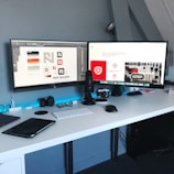 Professional remote workspace with dual monitors and clean layout.