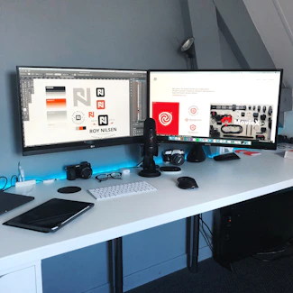 A modern workspace featuring multiple screens displaying partner brand logos.