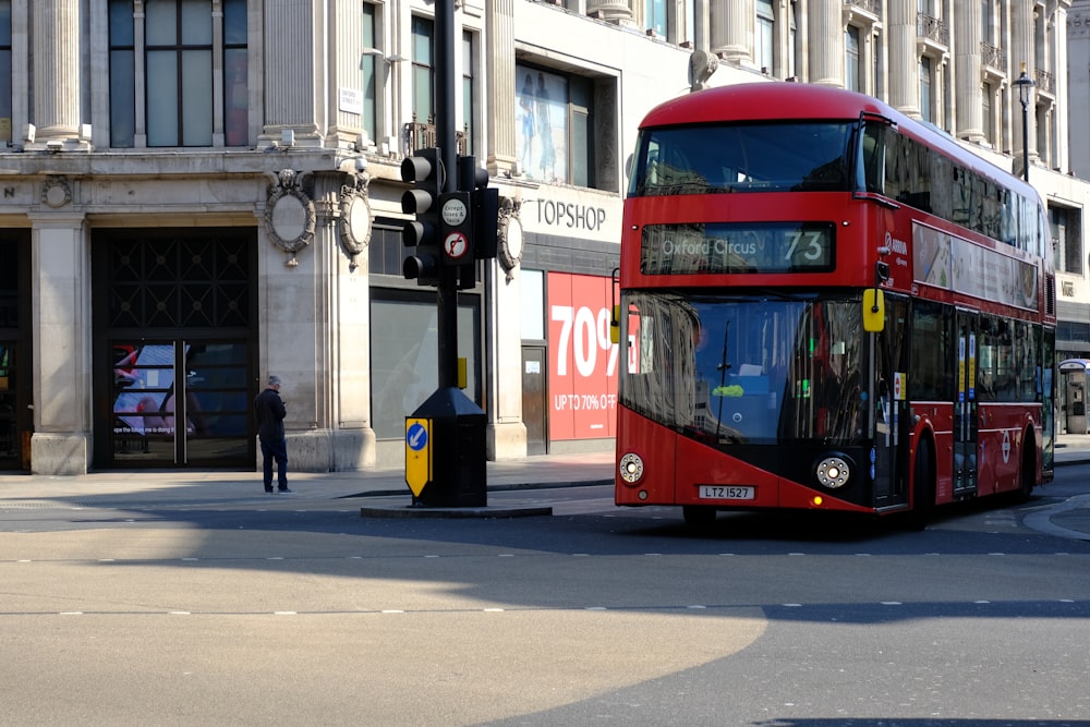 red and black double decker bus on road during daytime