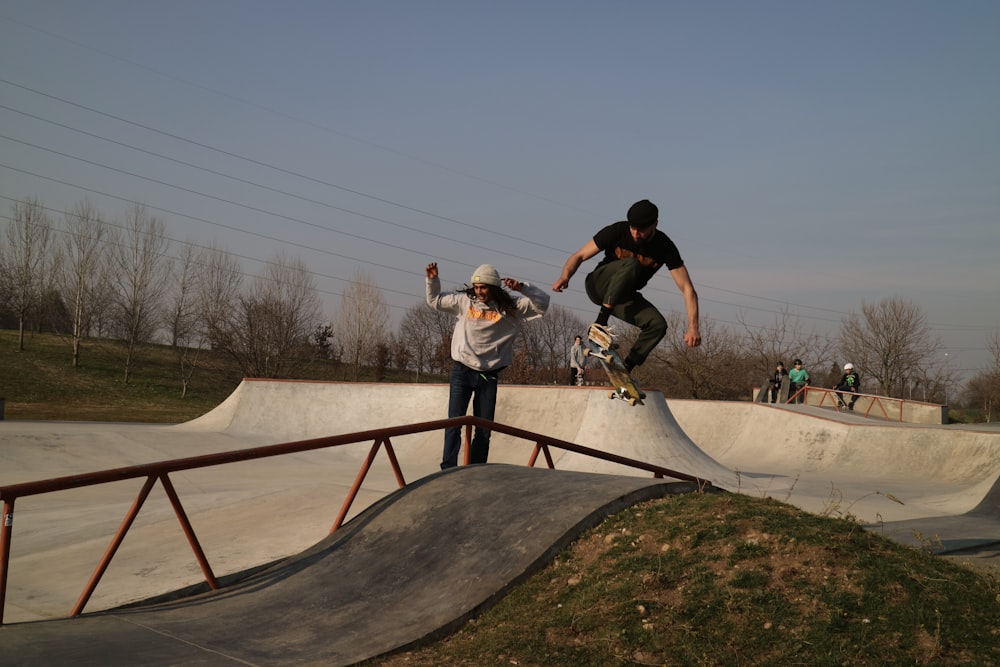 man in black t-shirt and black pants doing skateboard trick