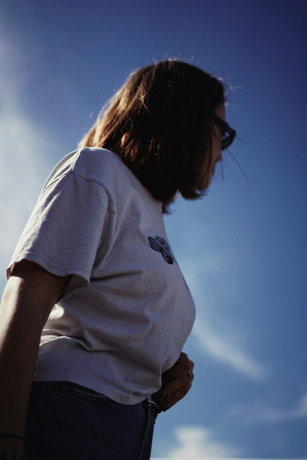 woman in white t-shirt and blue denim bottoms