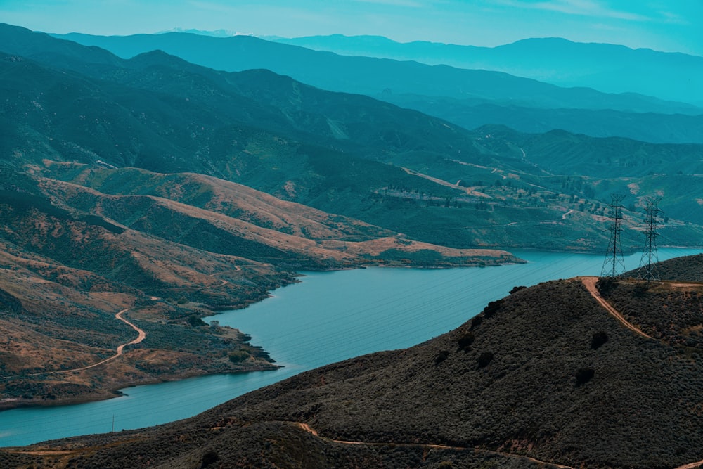 aerial view of lake in the middle of mountains during daytime