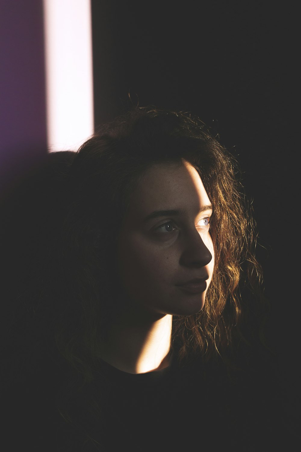 woman with brown hair looking up