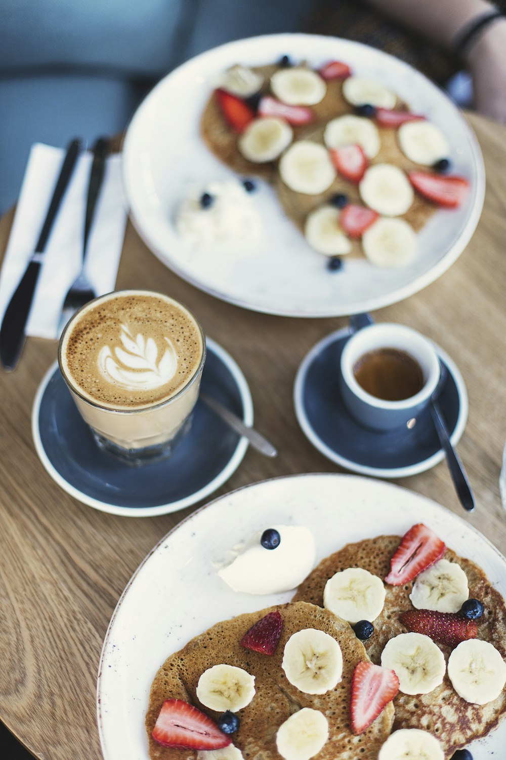 cappuccino in white ceramic mug on white ceramic saucer