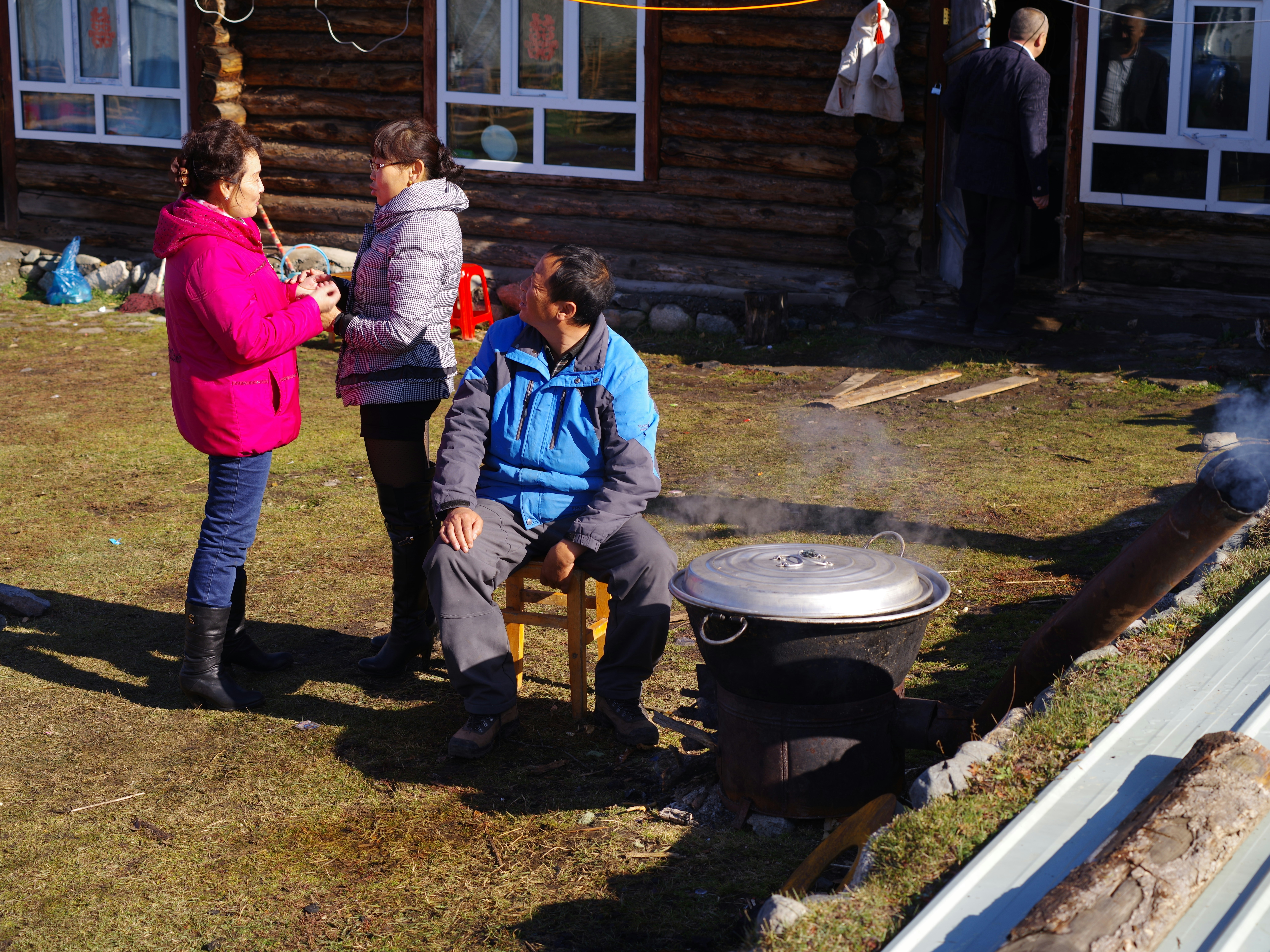 people standing near brown wooden house during daytime
