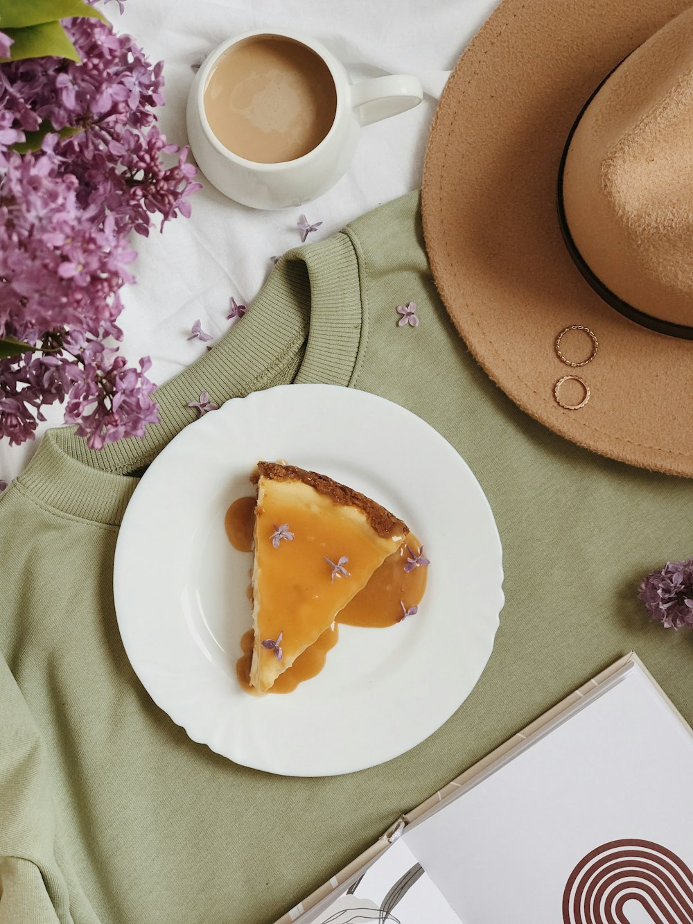 a piece of pie on a plate next to a cup of coffee