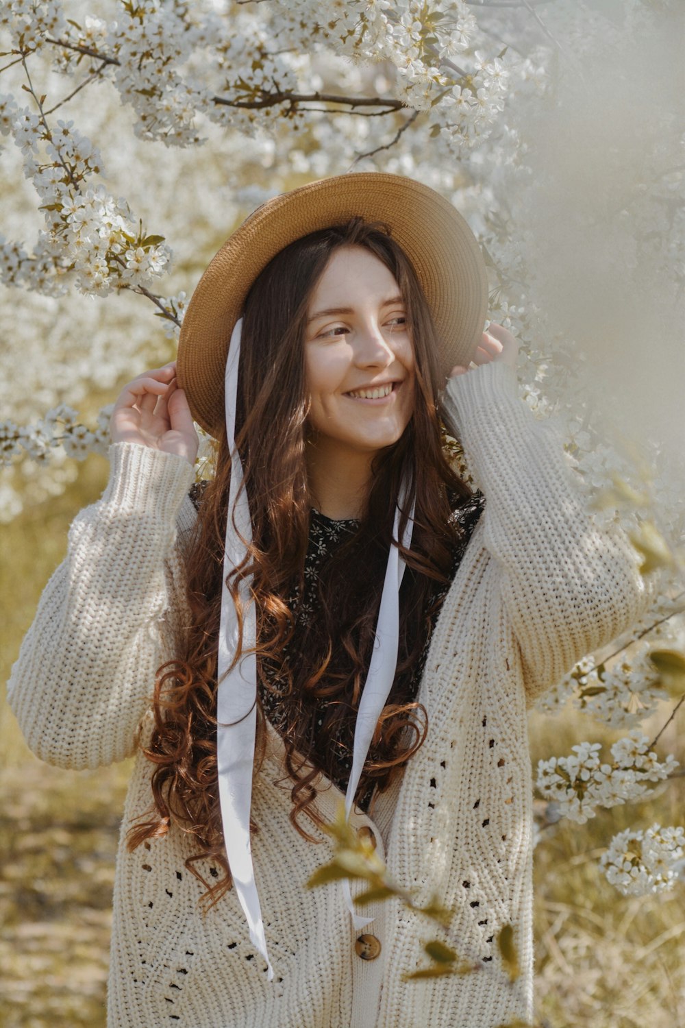 woman in brown sun hat and brown coat