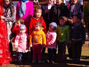 A group of children playing in colorful outfits at a park.