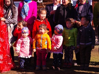 A group of children playing in colorful outfits at a park.