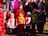 A joyful family wearing colorful outfits in a park.