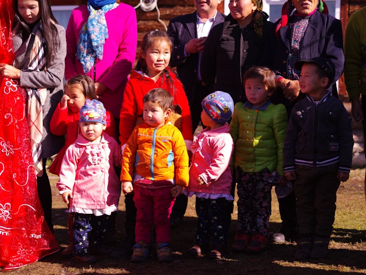 A vibrant group shot of men, women, and kids wearing casual, colorful allwear apparel outdoors.