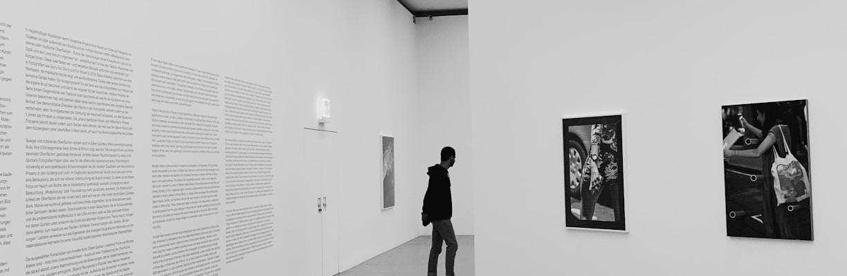 woman walking on hallway in grayscale photography