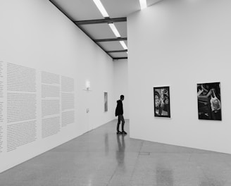 woman walking on hallway in grayscale photography