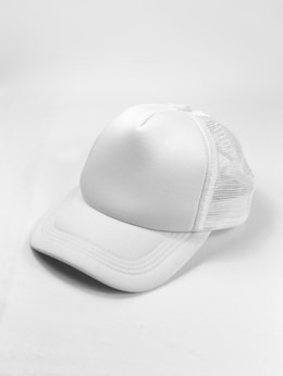 white baseball cap on white surface