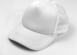 white baseball cap on white surface