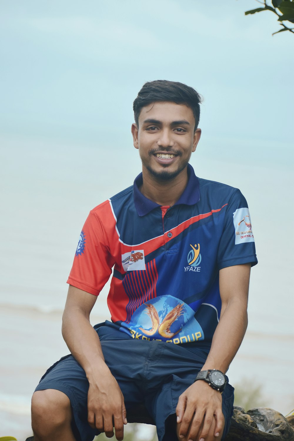 smiling boy in blue and red polo shirt