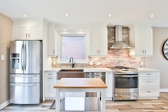 white top mount refrigerator beside white wooden kitchen cabinet