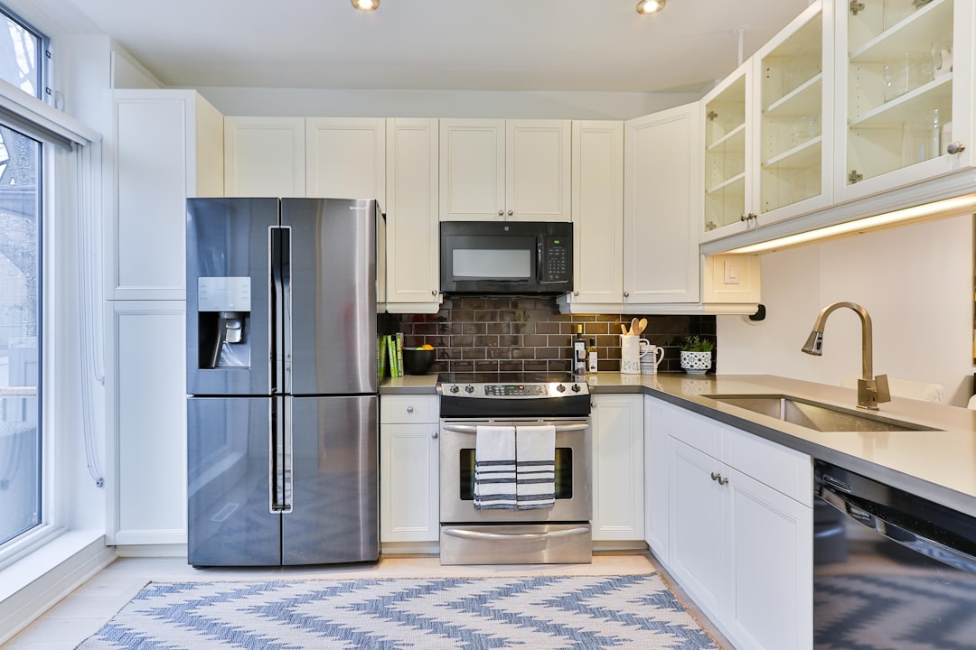  silver french door refrigerator beside white wooden kitchen cabinet refrigerator