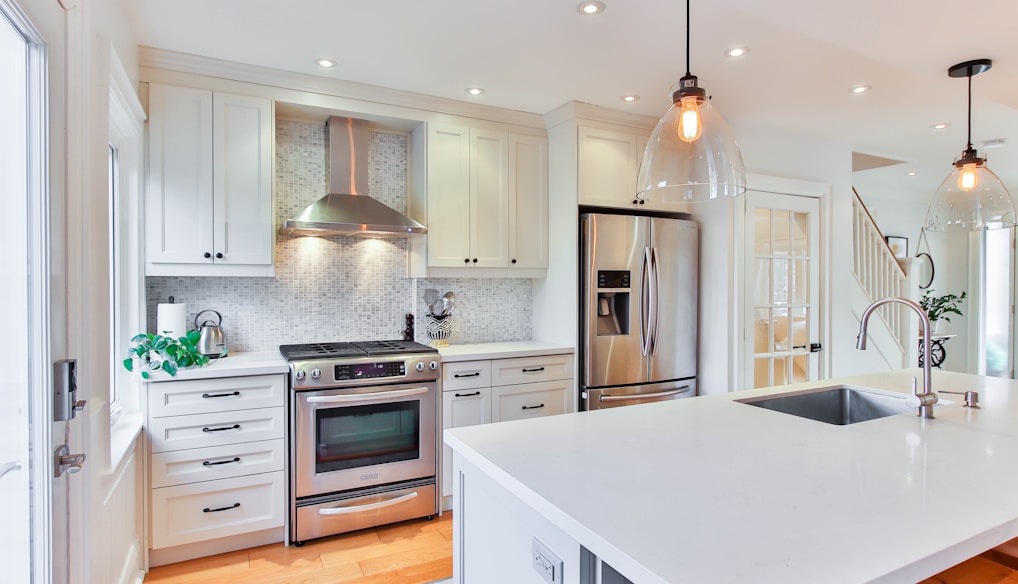 white wooden kitchen cabinet and white kitchen counter