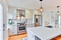 white wooden kitchen cabinet and white kitchen counter