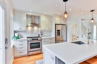 white wooden kitchen cabinet and white kitchen counter