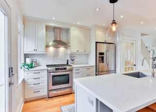 white wooden kitchen cabinet and white kitchen counter