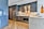 Close-up of a sleek, modern kitchen featuring dark gray cabinetry and wooden countertops with soft lighting.