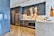 A sleek, contemporary kitchen featuring marble countertops and stylish cabinetry.