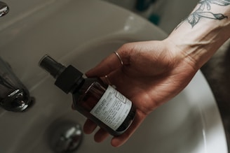 person holding white labeled bottle