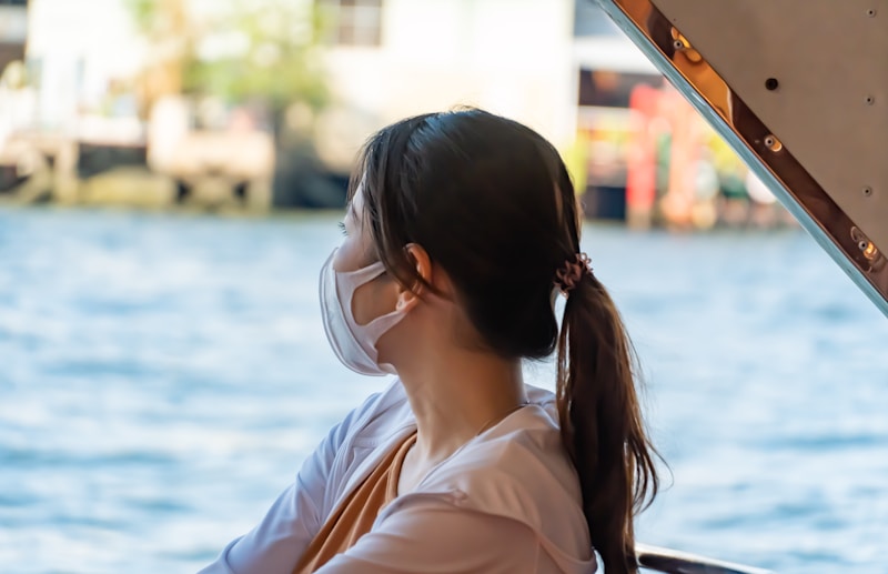 Stylish woman in white on yacht