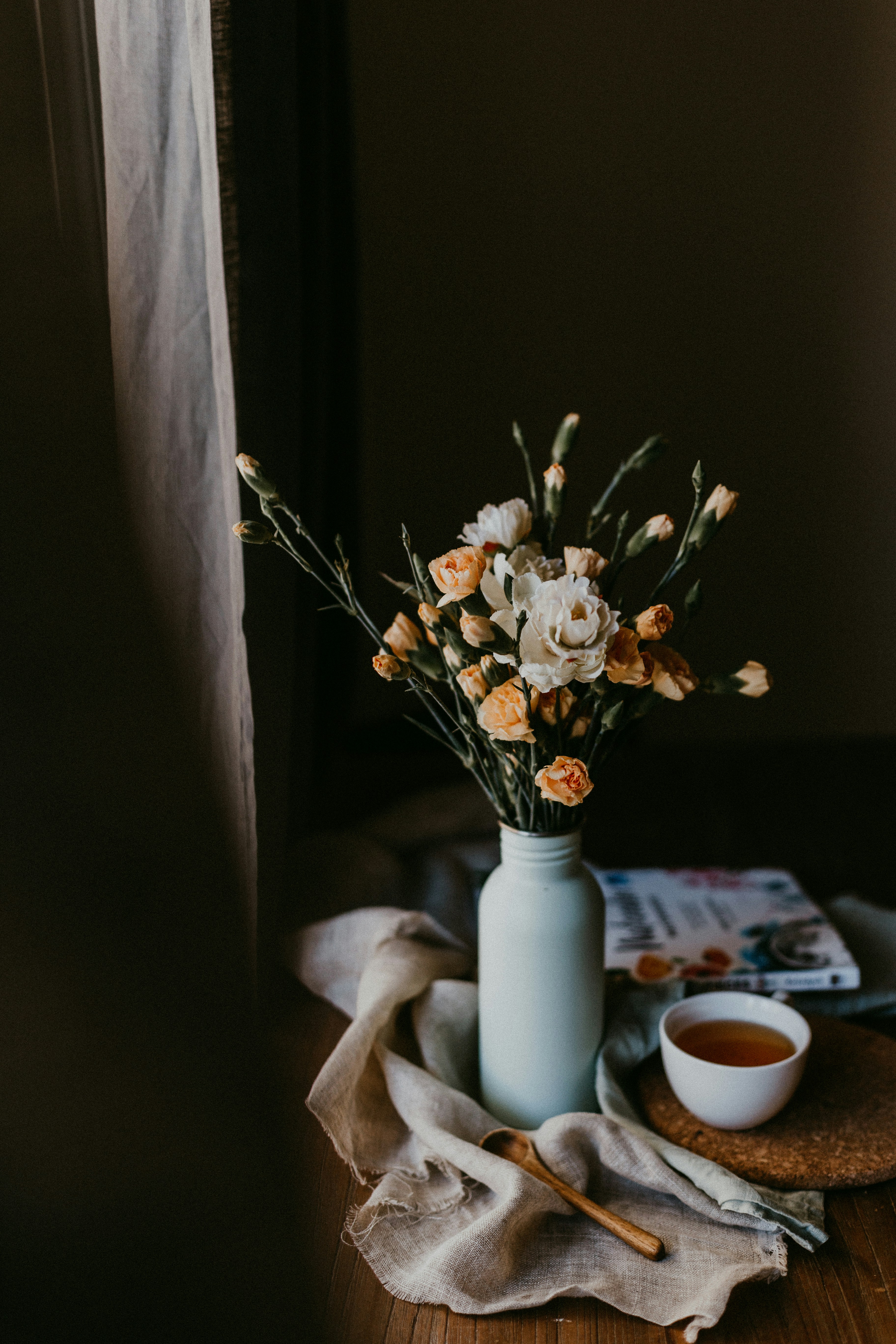 white flowers in white ceramic vase