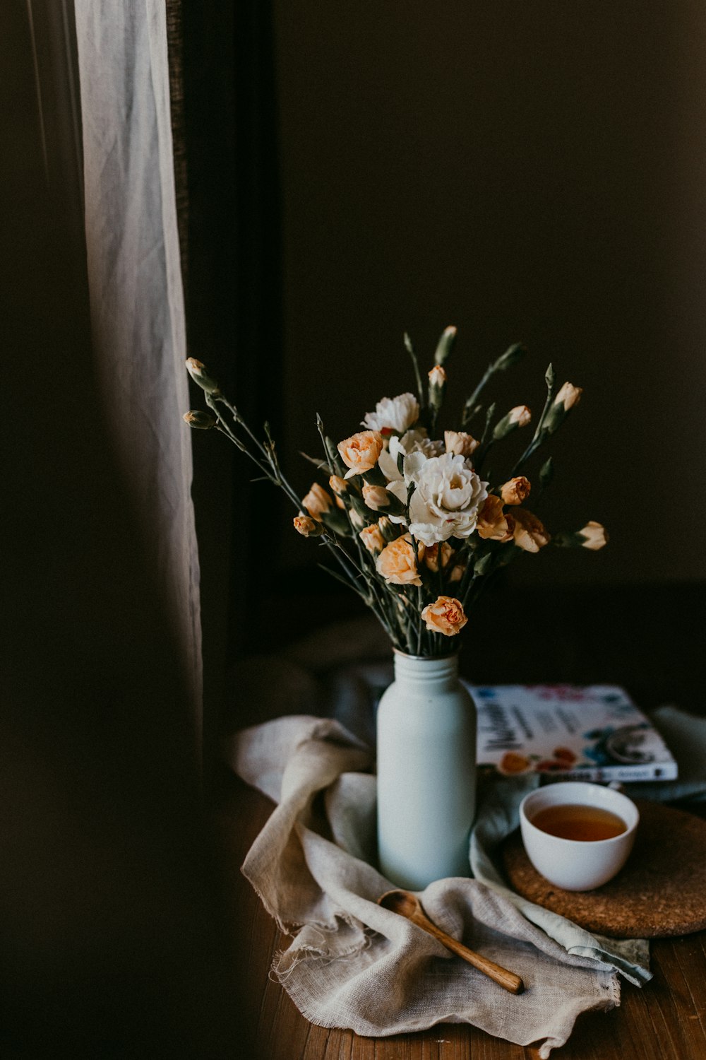 white flowers in white ceramic vase