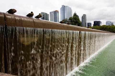 water fountain near high rise buildings during daytime