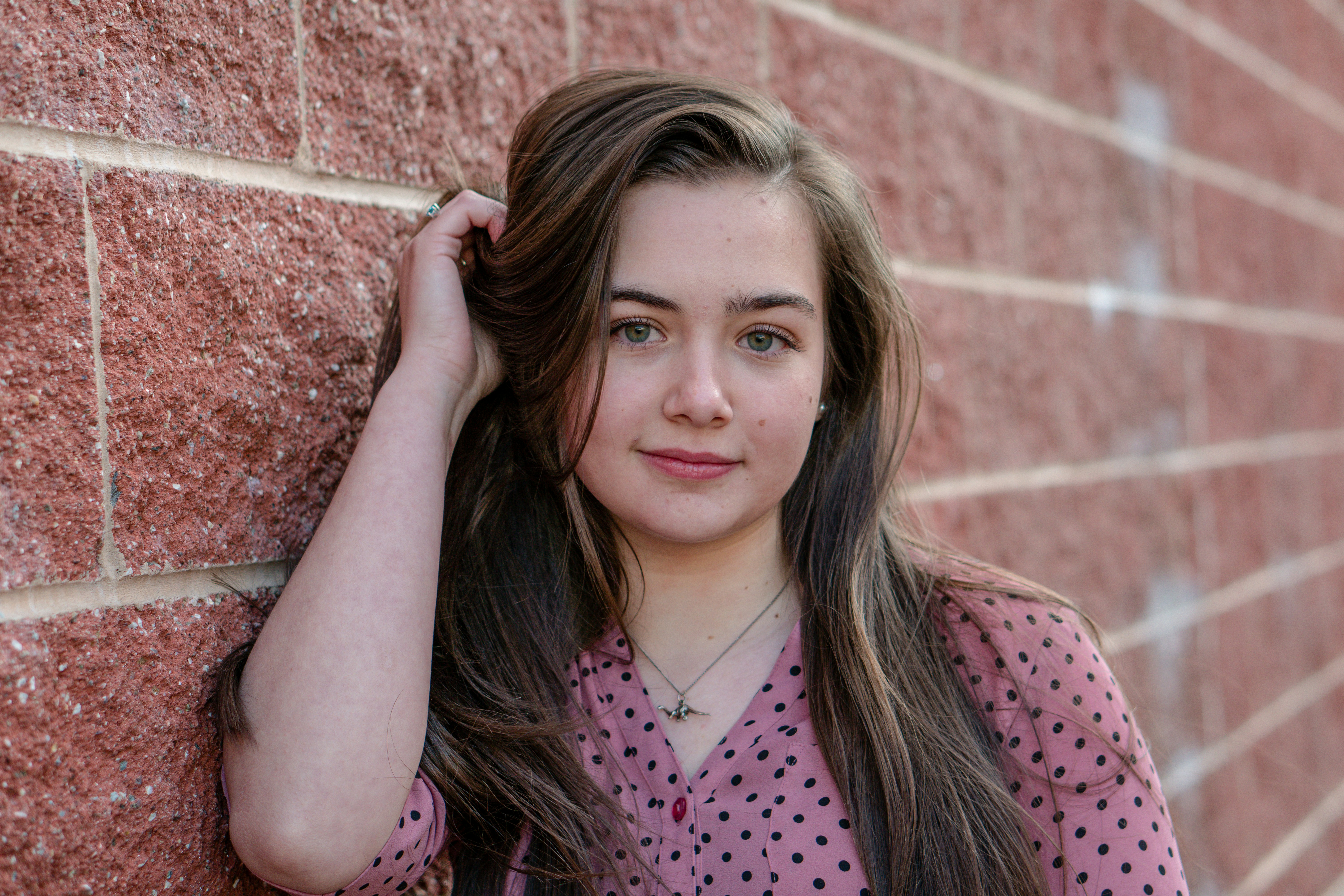woman in pink and black polka dot shirt