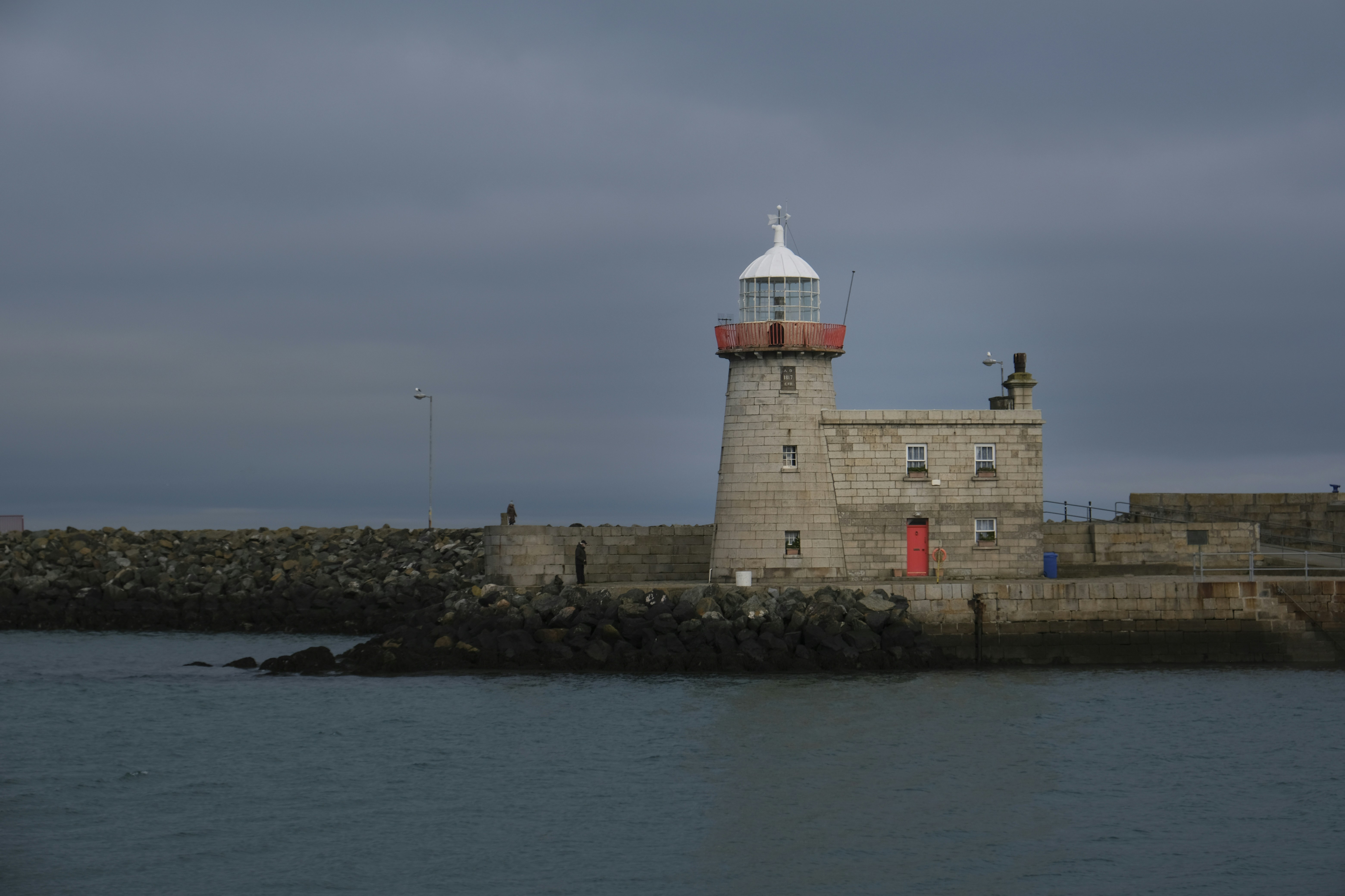 edificio in cemento bianco e marrone vicino allo specchio d'acqua durante il giorno