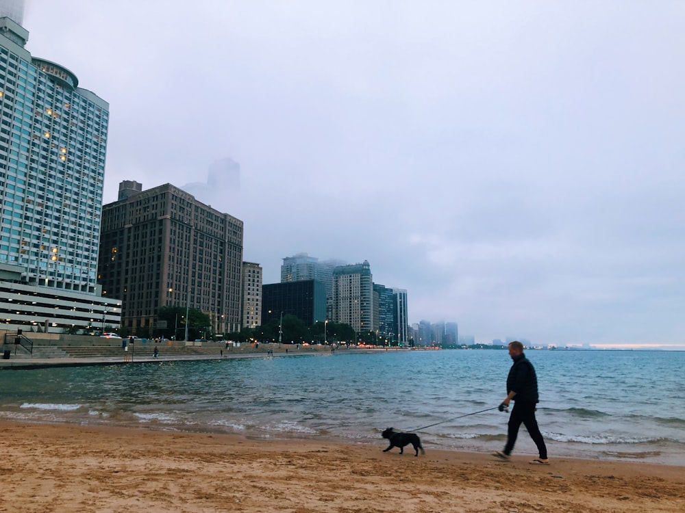 man and woman walking on beach during daytime