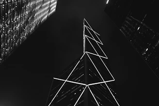 Night view of a premium urban skyline with golden lights reflecting on glass towers.