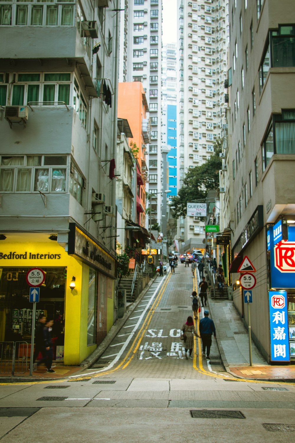 a narrow city street lined with tall buildings