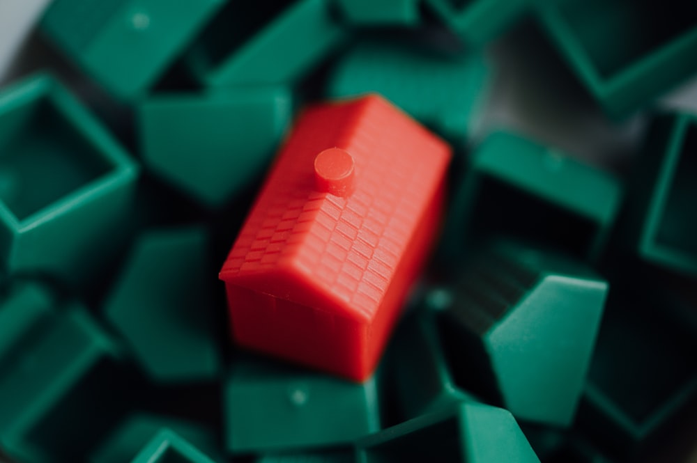 red plastic toy on black surface