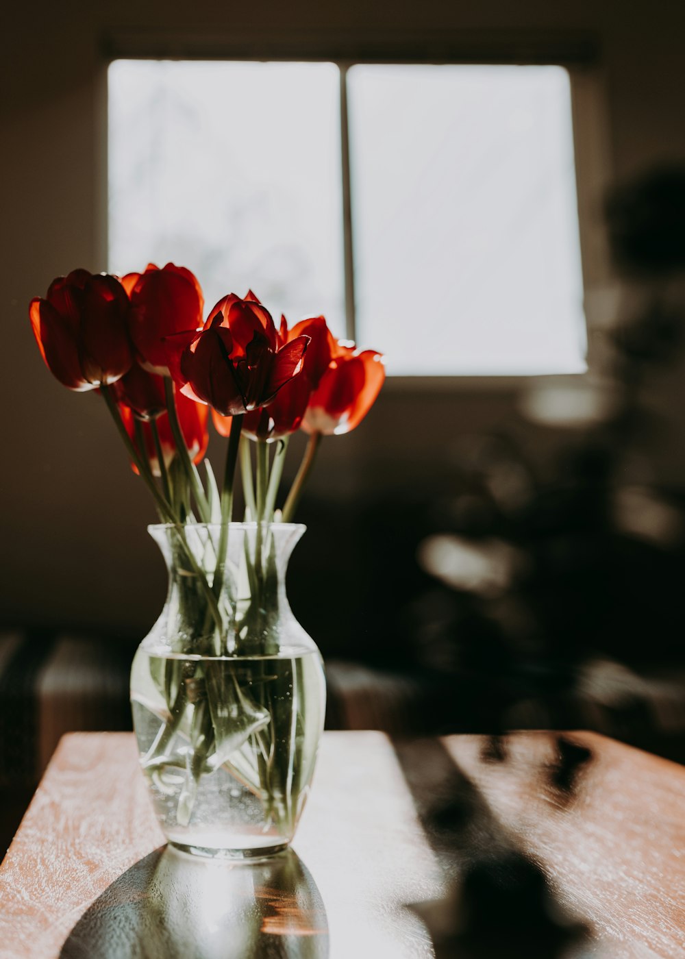 red roses in clear glass vase