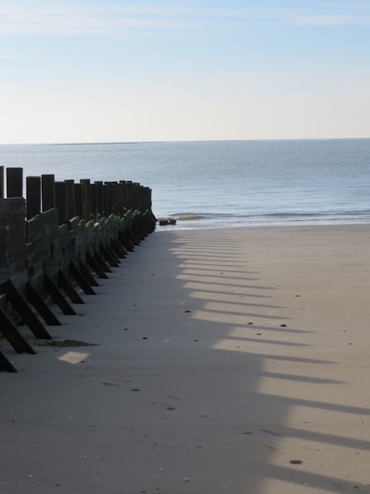 gray wooden fence on beach during daytime in Noirmoutier France