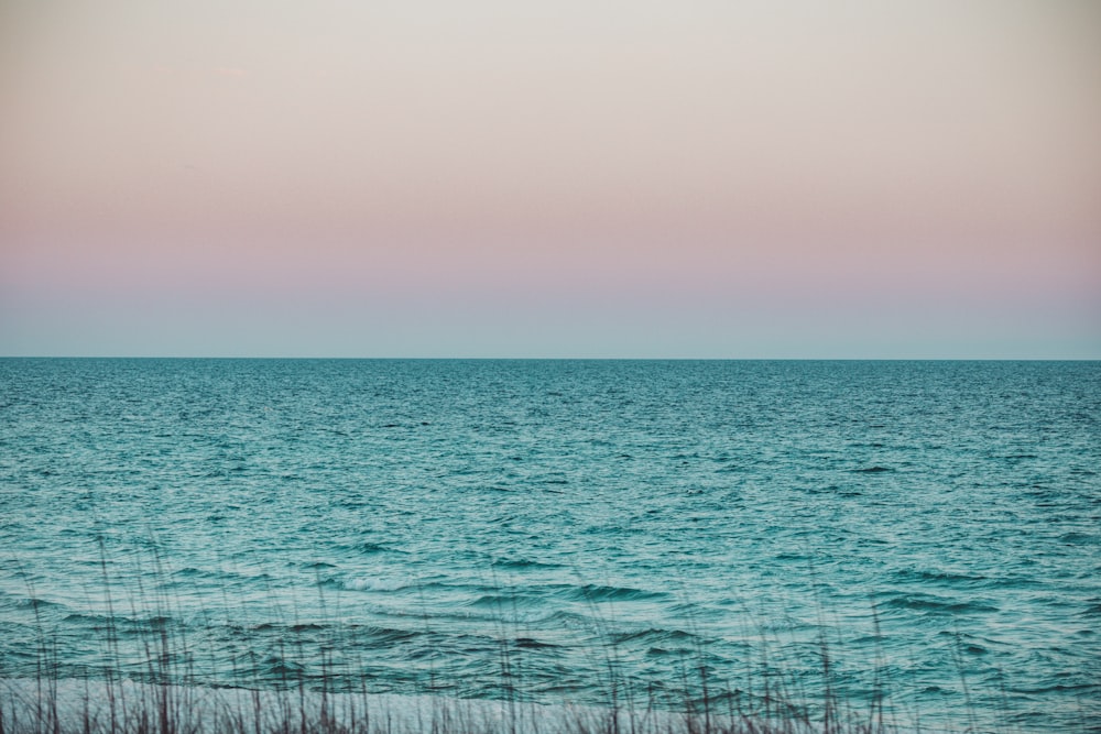 body of water under gray sky