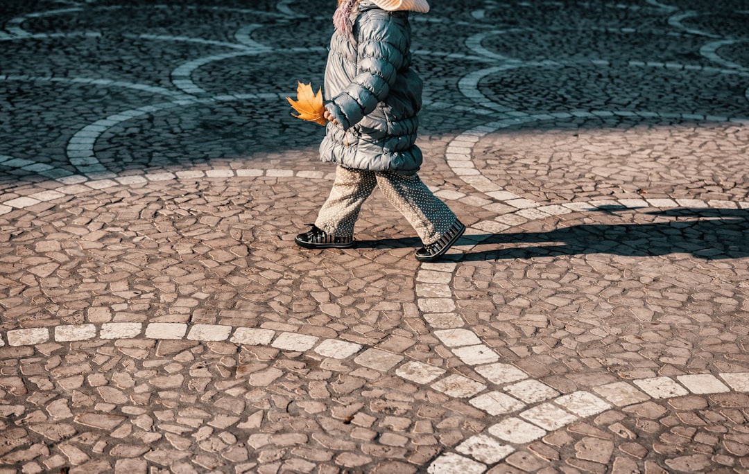 man in white and black jacket and pants standing on gray concrete floor