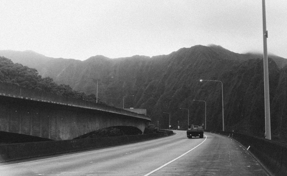 grayscale photo of car on road