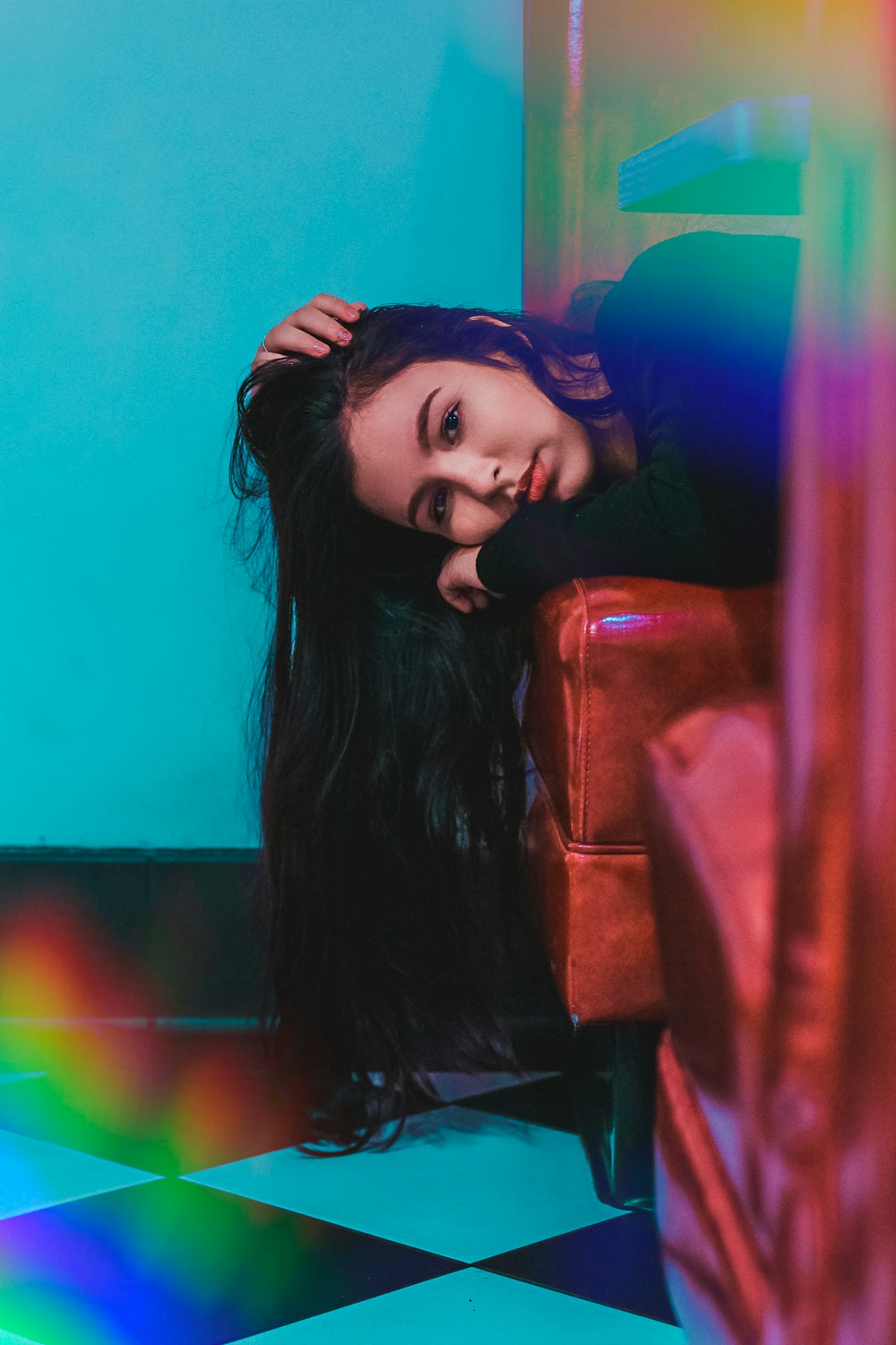 woman in black long sleeve shirt sitting on brown leather couch