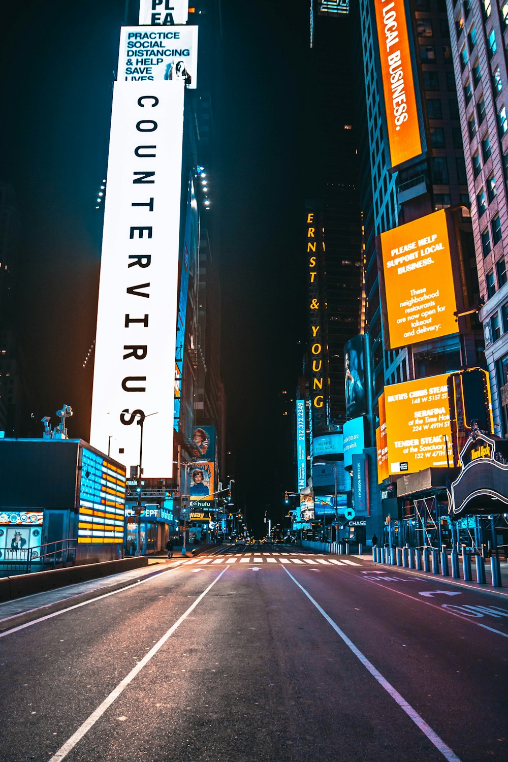 city street with high rise buildings during night time