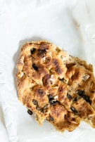 A warm basket of freshly baked, golden bread served with olive oil and herbs.