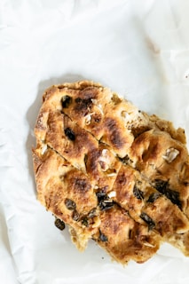 A warm basket of freshly baked, golden bread served with olive oil and herbs.