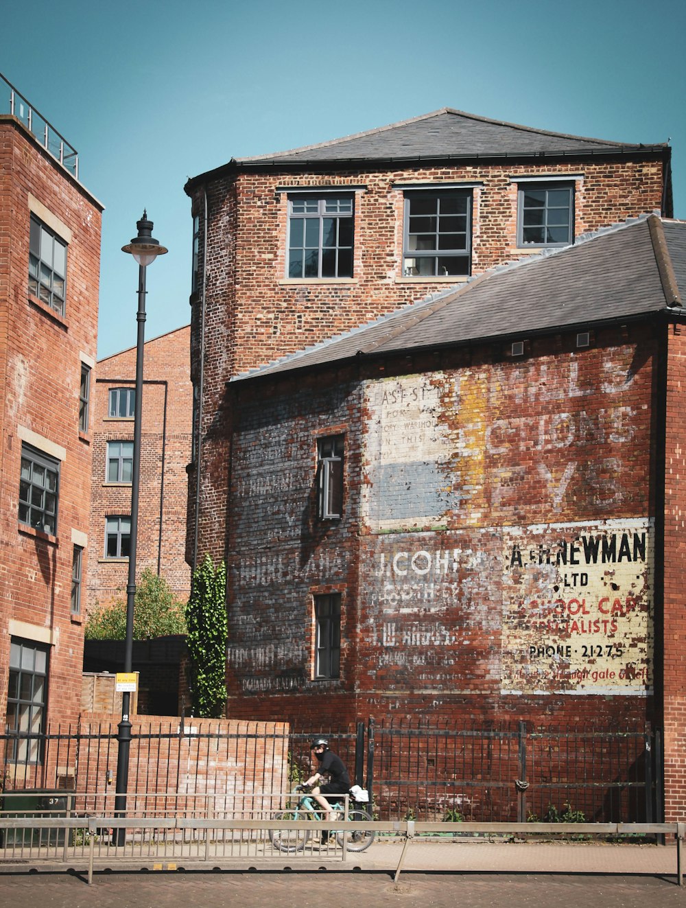 brown brick building near green trees during daytime